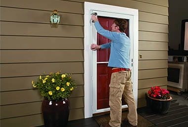 Andersen Full-Lite Self-Storing Storm Door Installation, securing door. Andersen Full-Lite Self-Storing Storm Door Installation, securing door.